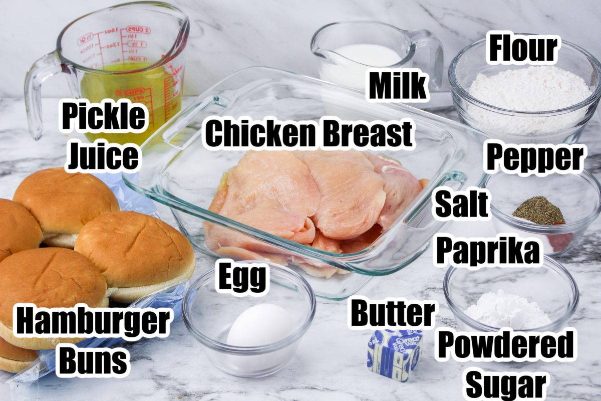 Ingredients for copycat chick fil a chicken sandwich in bowls from the side with labels on the bowls