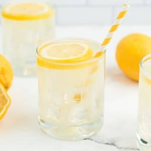 lemonade in glass with yellow and white straw