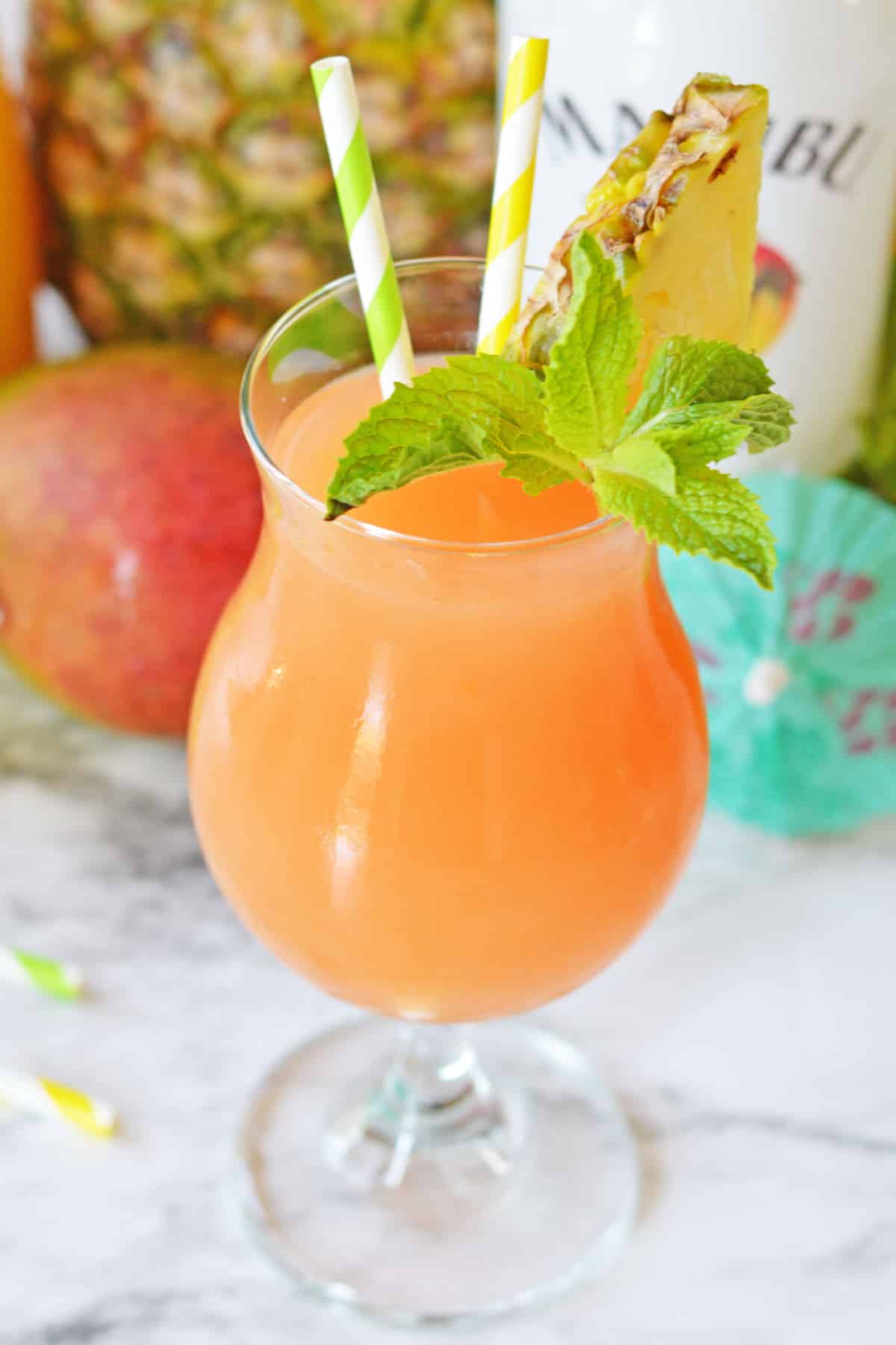 Pineapple mango rum punch in hurricane glass
