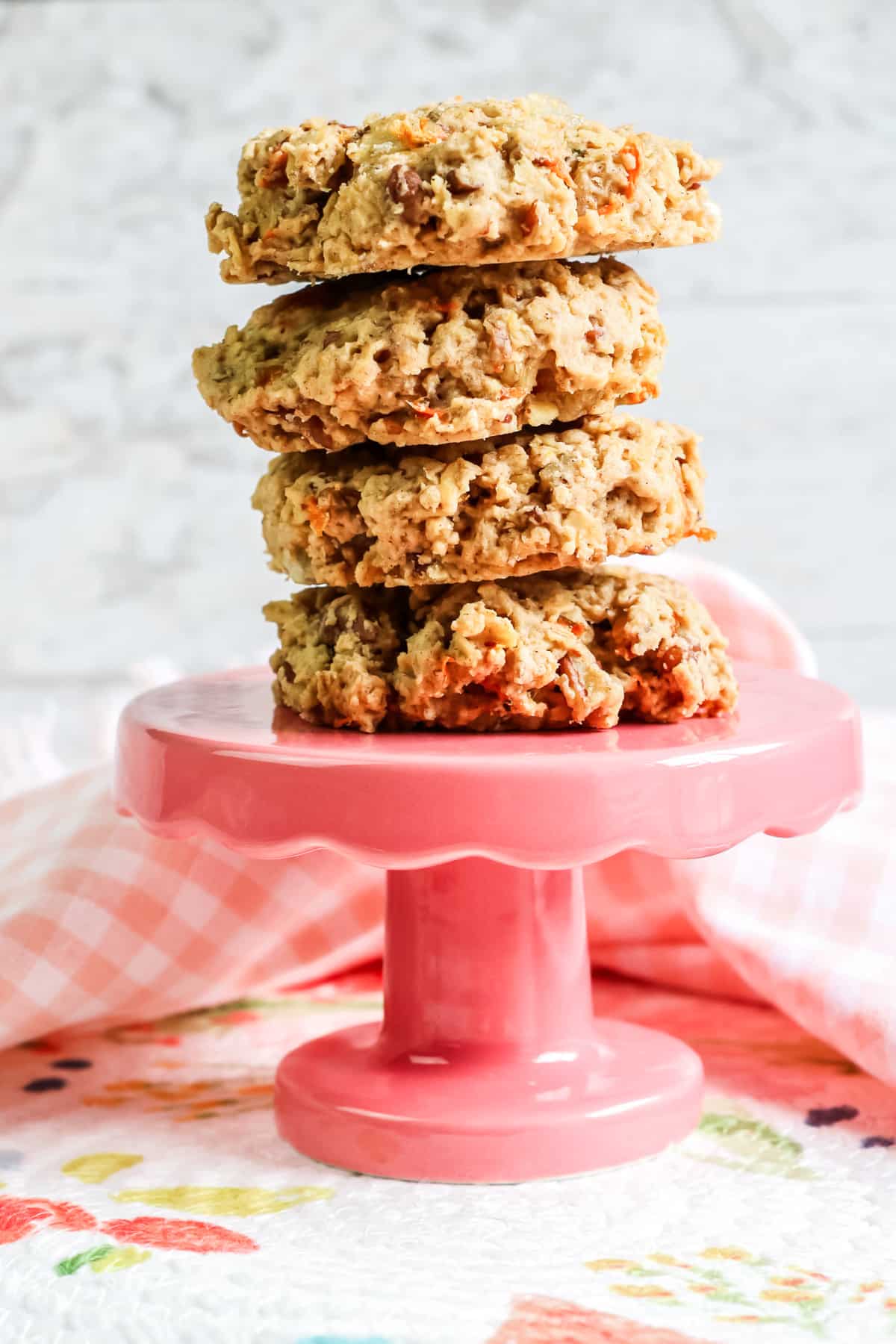 Four carrot oatmeal cookies stacked on a serving platter.