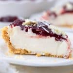 Slice of cherry cheesecake on a white plate