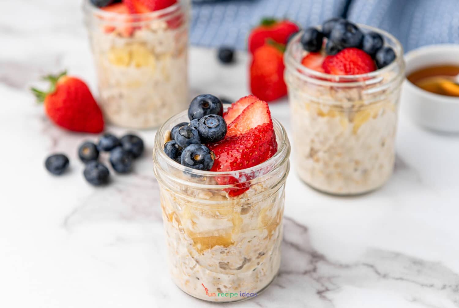 3 jars of overnight oats without chia seeds with garnishes.