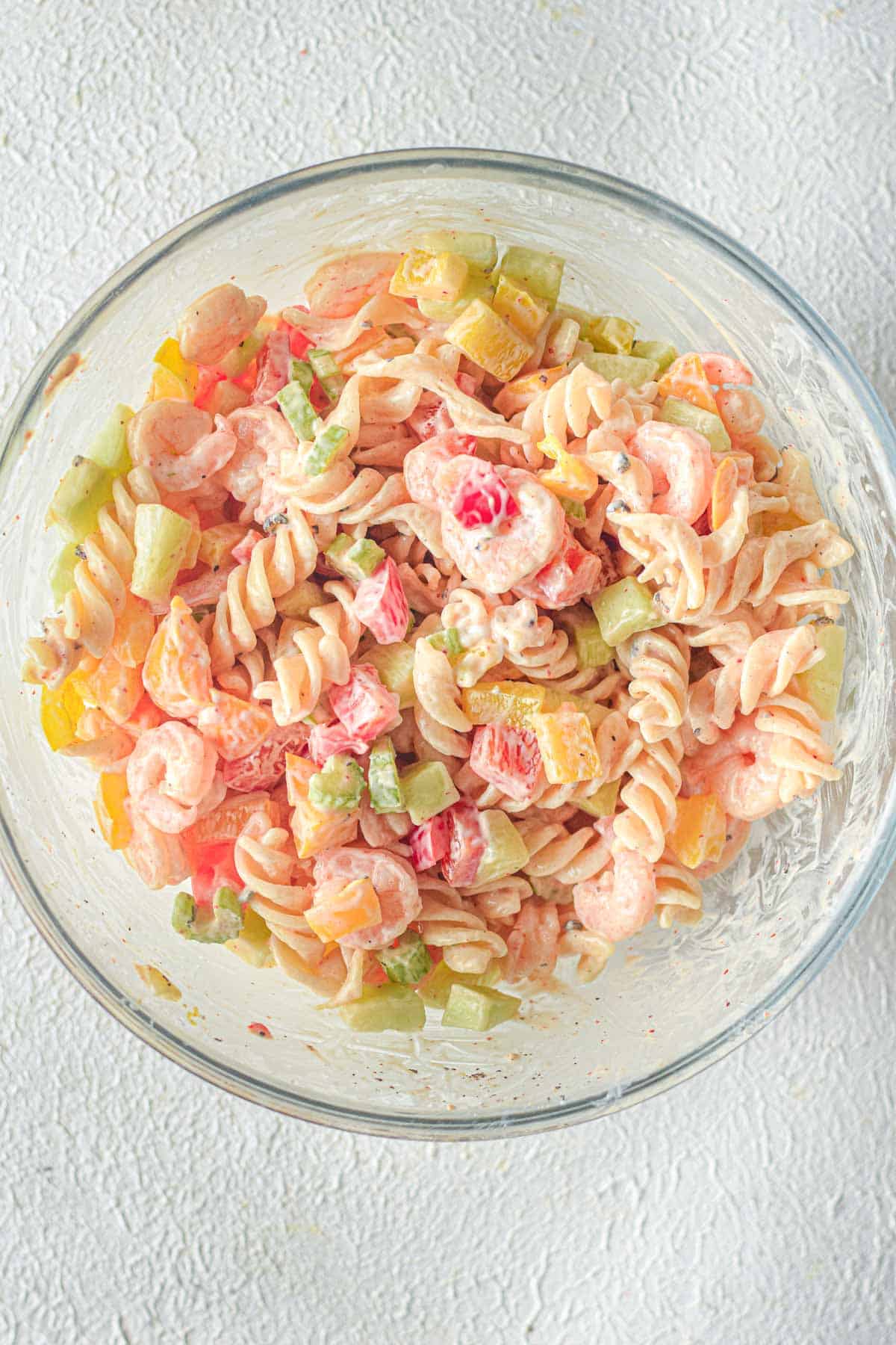 shrimp and pasta in clear mixing bowl