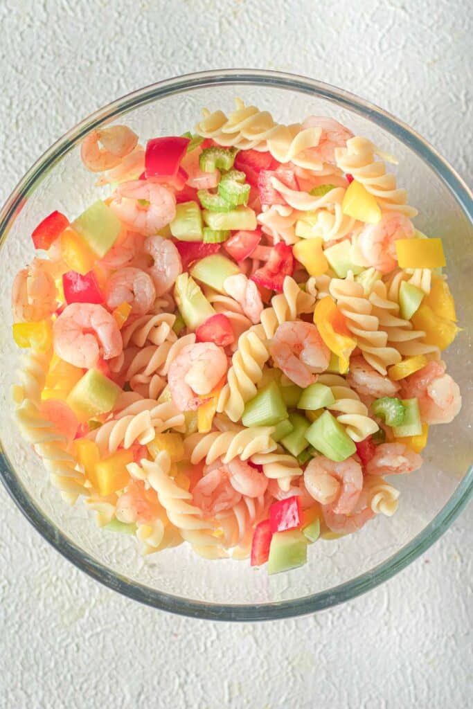 pasta, shrimp and vegetables in glass mixing bowl