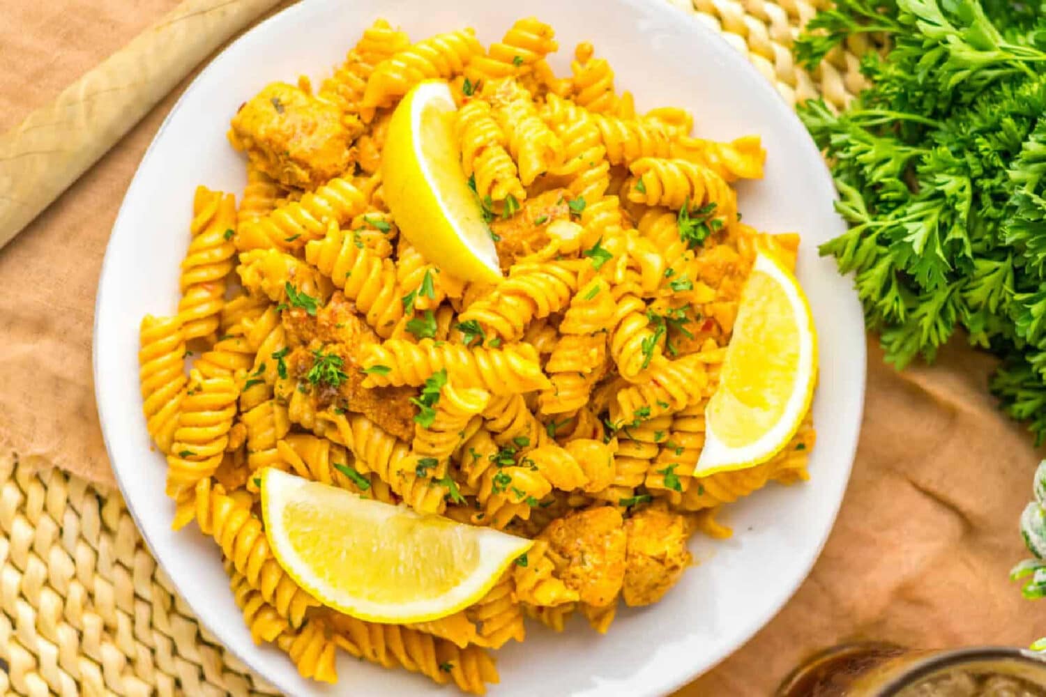 Cowboy butter pasta on a plate with slices of lemon.